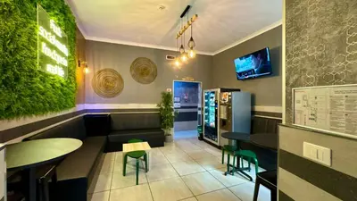 a restaurant with tables and chairs in a room at Star City Guest House in Rome