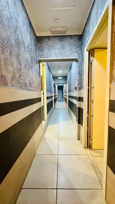 a hallway in a building with a long corridor at Star City Guest House in Rome
