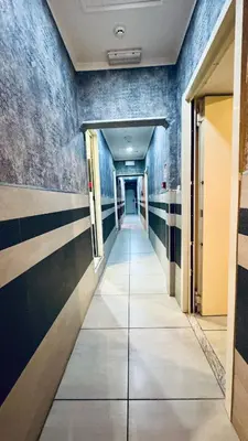 a hallway in a building with blue walls at Star City Guest House in Rome