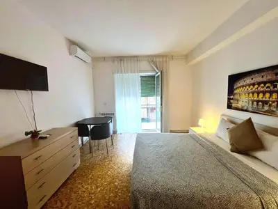 a bedroom with a bed and a table and a window at Montitiburtini Appartamento 510 Roma Centro in Rome