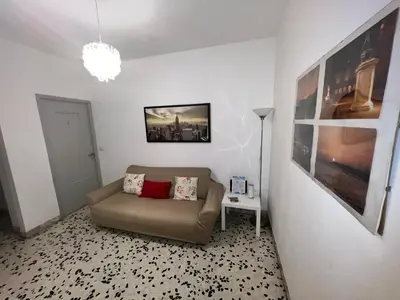 a living room with a couch and a lamp at Montitiburtini Appartamento 510 Roma Centro in Rome