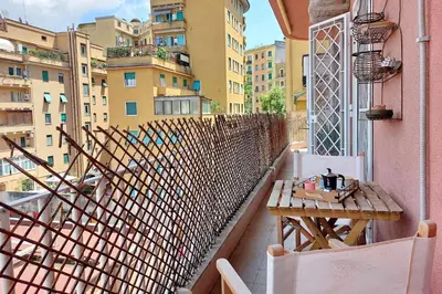 a balcony with a table and a fence and some buildings at Flaminio Arte & Musica in Rome
