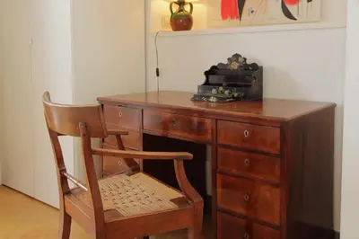 a wooden desk with a chair and a radio on it at Flaminio Arte & Musica in Rome