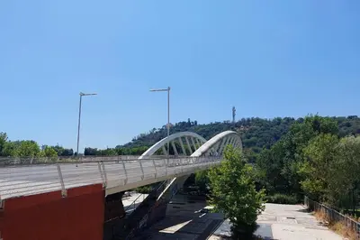 a bridge over a highway with trees on the horizon at Flaminio Arte & Musica in Rome
