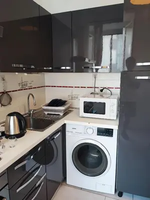 a kitchen with a washing machine and a microwave at Residenza Giolitti in Rome