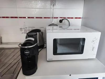 a microwave sitting on top of a kitchen counter at Residenza Giolitti in Rome