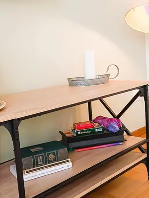 a wooden table with books on a shelf at MamaCri rifugio d'inverno a Roma in Rome