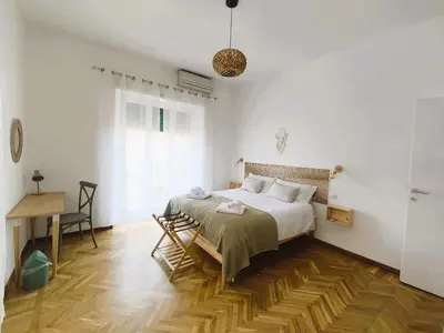 a bedroom with a bed and a desk in it at MamaCri rifugio d'inverno a Roma in Rome