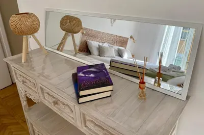 a table with books on it with a mirror at MamaCri rifugio d'inverno a Roma in Rome