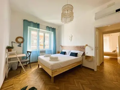 a bedroom with a bed and a chandelier at MamaCri rifugio d'inverno a Roma in Rome