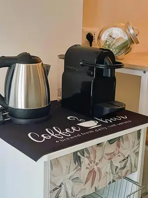 a counter with a coffee maker and a tea kettle at MamaCri rifugio d'inverno a Roma in Rome