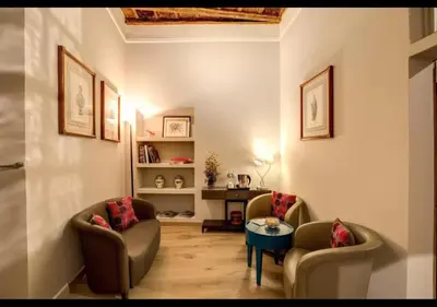 a living room with two chairs and a table at Stunning 2bedrooms apartment with AC Via Giulia in Rome