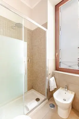 a bathroom with a shower and a toilet and a sink at Stunning 2bedrooms apartment with AC Via Giulia in Rome