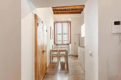 a kitchen with a table and a dining room at Stunning 2bedrooms apartment with AC Via Giulia in Rome