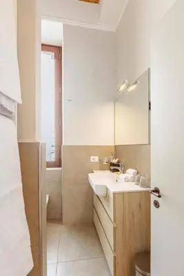 a bathroom with a sink and a mirror at Stunning 2bedrooms apartment with AC Via Giulia in Rome