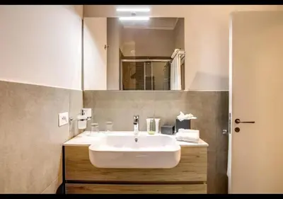 a bathroom with a white sink and a mirror at Stunning 2bedrooms apartment with AC Via Giulia in Rome