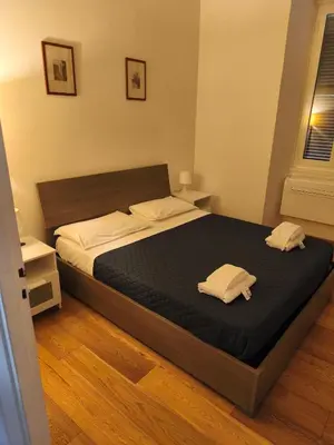 a bedroom with a bed with two towels on it at Suite Tevere star in Rome