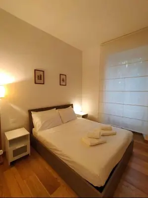 a bedroom with a bed with two towels on it at Suite Tevere star in Rome
