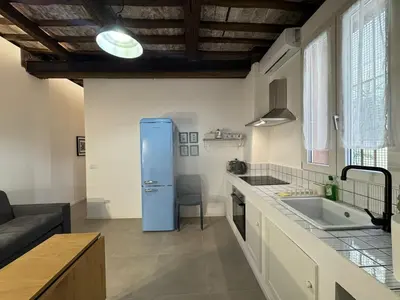 a kitchen with a blue refrigerator in a room at Cozy Corner in Magical Trastevere in Rome