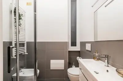 a bathroom with a toilet and a sink at The Best Rent - Modern one-bedroom apartment in the Porta Pia area in Rome
