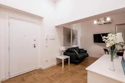 a living room with a black couch and a table at The Best Rent - Modern one-bedroom apartment in the Porta Pia area in Rome