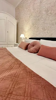 a large white bed with two pillows on it at Vatican Museum YH in Rome