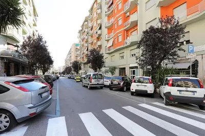 a city street with cars parked on the street at Vatican Museum YH in Rome
