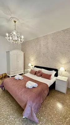 a bedroom with a large bed with two towels on it at Vatican Museum YH in Rome