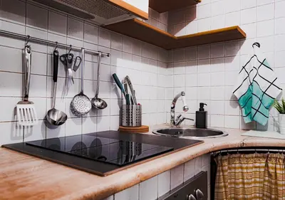 a kitchen with a sink and a counter with utensils at Trastevere Urban Loft in Rome