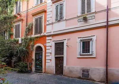 an orange and pink building with a door at Trastevere Urban Loft in Rome