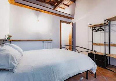a bedroom with a white bed and a wooden ceiling at Trastevere Urban Loft in Rome