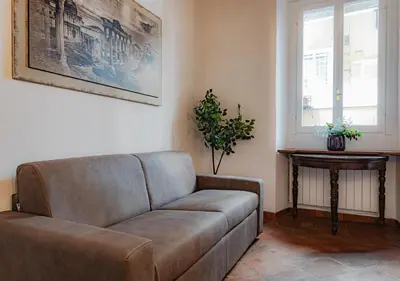 a living room with a couch and a table at Trastevere Urban Loft in Rome