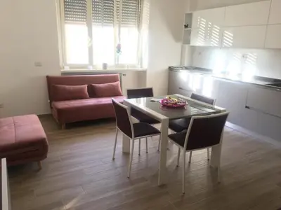 a living room with a table and chairs and a couch at Francy's home sweet home in Rome