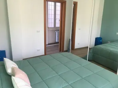 a bedroom with a large green bed and a mirror at Francy's home sweet home in Rome