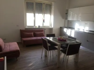 a living room with a table and chairs and a couch at Francy's home sweet home in Rome