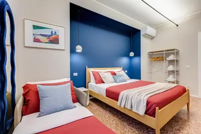 two beds in a bedroom with blue and white walls at BDC - Trevi Premium 3BDR - 3BATH in Rome