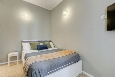 a small bedroom with a bed in a room at BDC - Trevi Premium 3BDR - 3BATH in Rome