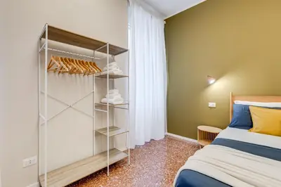 a bedroom with a bed and a closet at BDC - Trevi Premium 3BDR - 3BATH in Rome