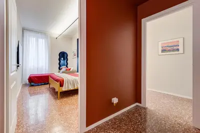 a room with a bedroom with a bed and a mirror at BDC - Trevi Premium 3BDR - 3BATH in Rome