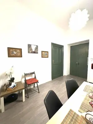 a dining room with green doors and a table and chairs at Caserina Lux Roma in Rome
