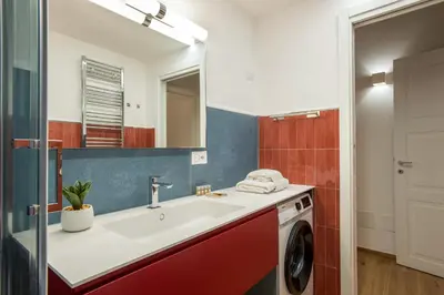 a bathroom with a sink and a washing machine at Margherita Flat in Rome