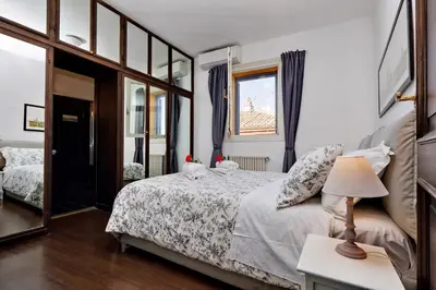 a bedroom with a bed and a mirror at Appartamento Lavatore in Rome