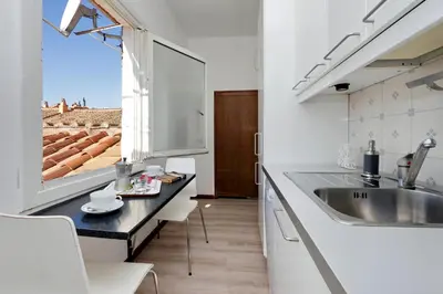 a kitchen with a sink and a large window at Appartamento Lavatore in Rome