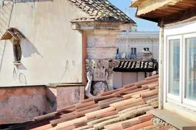 a building with a gargoyle on top of a roof at Appartamento Lavatore in Rome