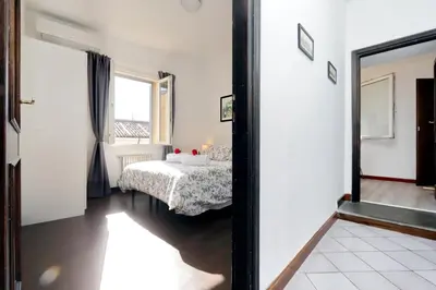a bedroom with a bed and a mirror at Appartamento Lavatore in Rome