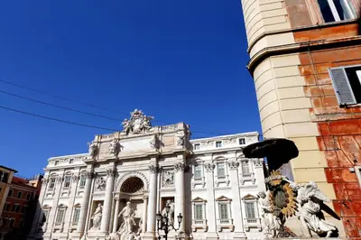 a large white building with statues in front of it at Appartamento Lavatore in Rome