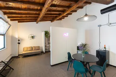 a room with a table and chairs and a couch at Loft Ostiense Green in Rome