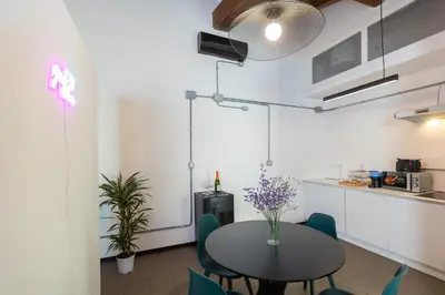 a kitchen and dining room with a table and chairs at Loft Ostiense Green in Rome