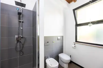 a bathroom with a toilet and a shower at Loft Ostiense Green in Rome