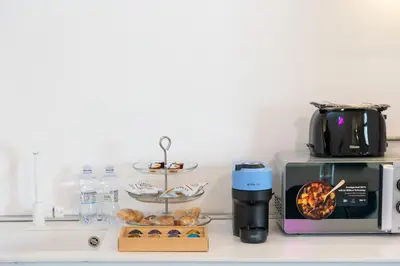 a kitchen counter with a coffee maker and a toaster at Loft Ostiense Green in Rome